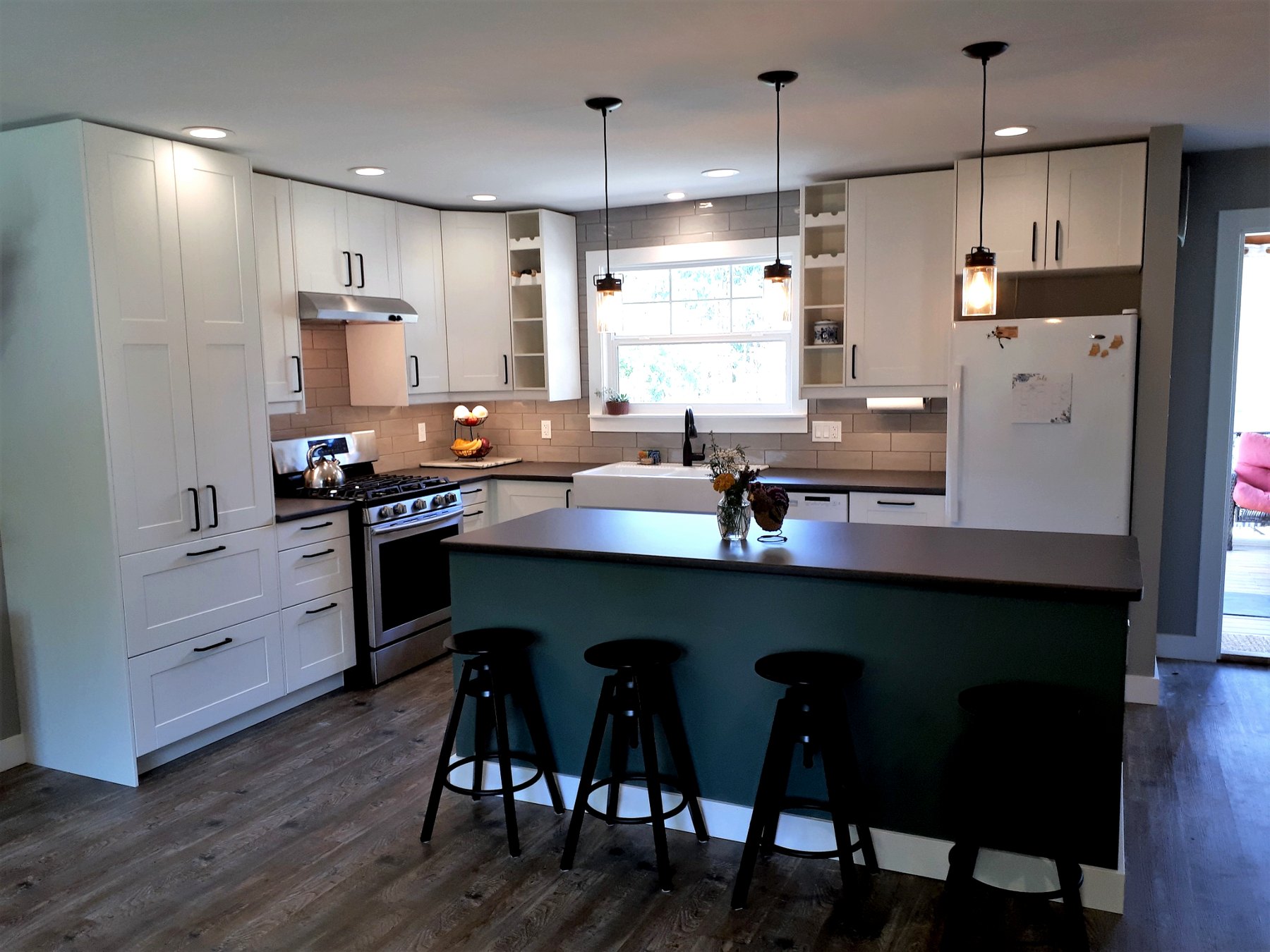 Bright and functional family kitchen featuring custom-installed IKEA cabinetry and oversized island seating.